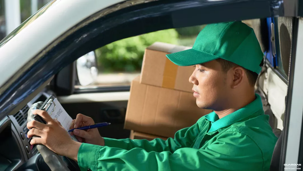 vehicle driver holding clipboard