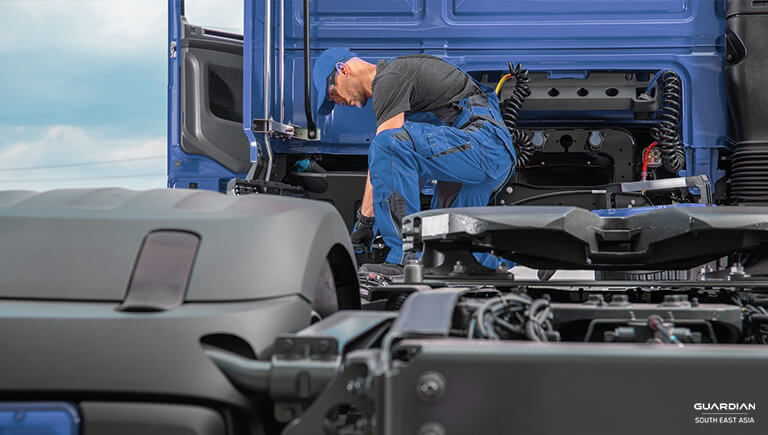 man fixing blue truck