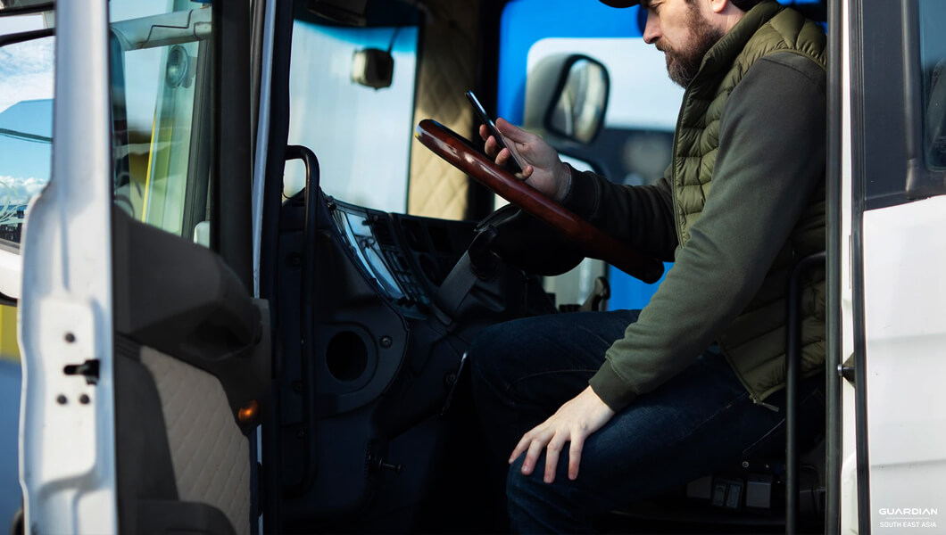 man in truck using mobile phone