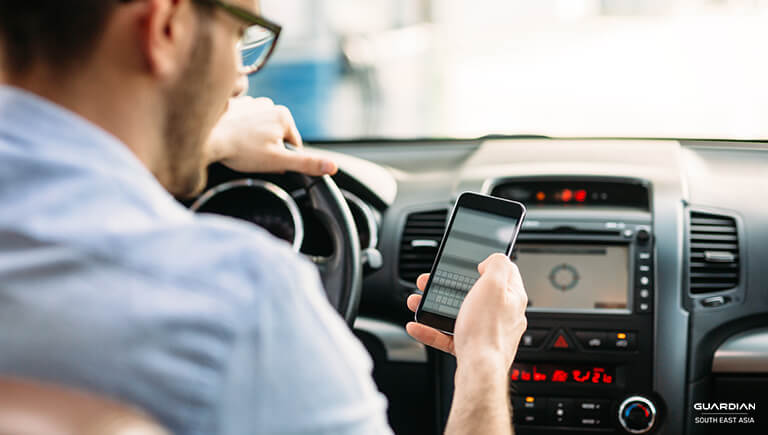 man texting in car