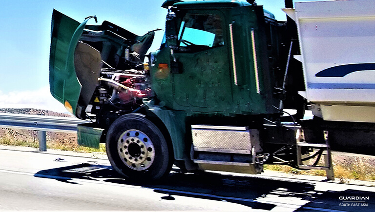 green truck with hood open